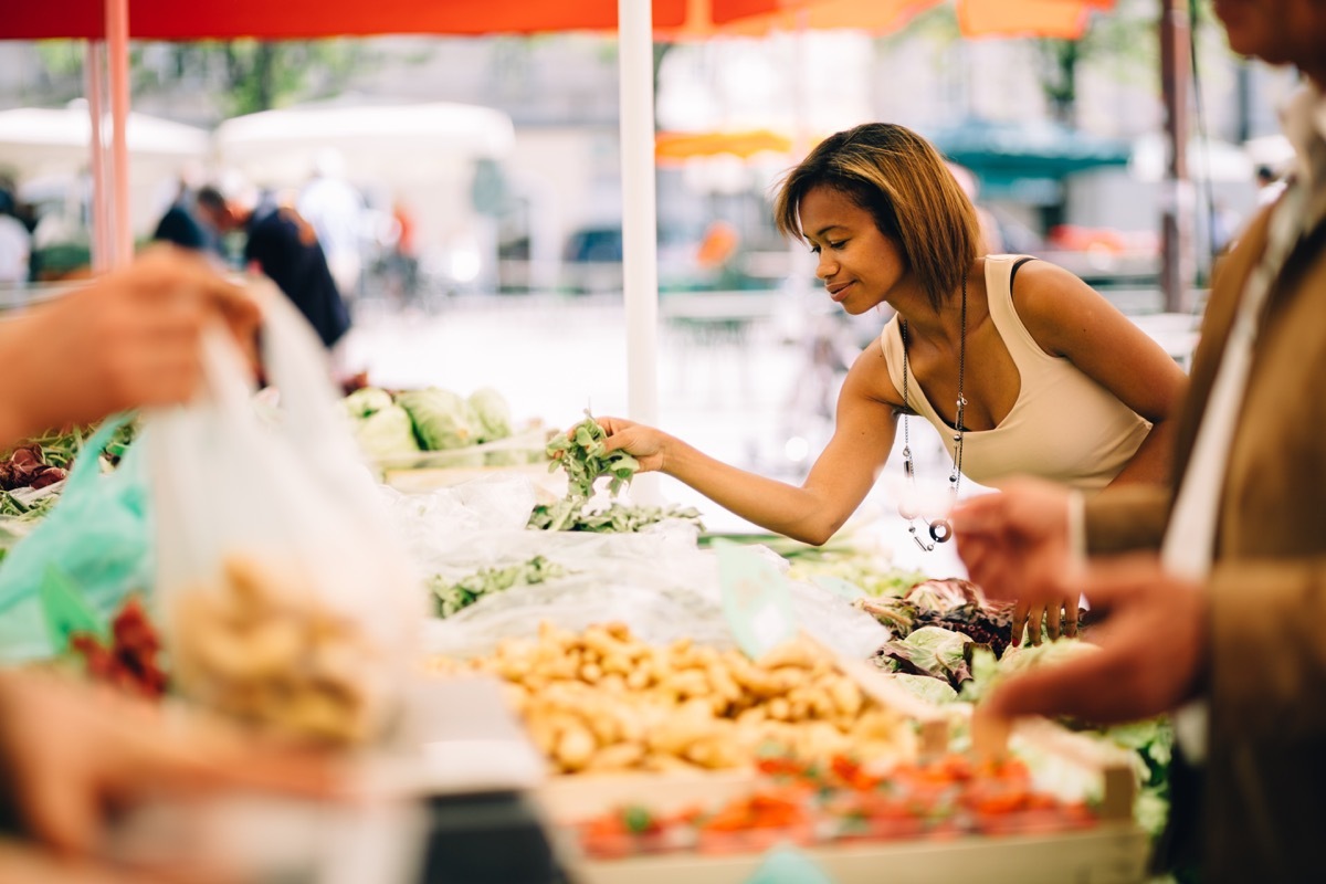 Black woman shopping for vegetables at the farmer's market