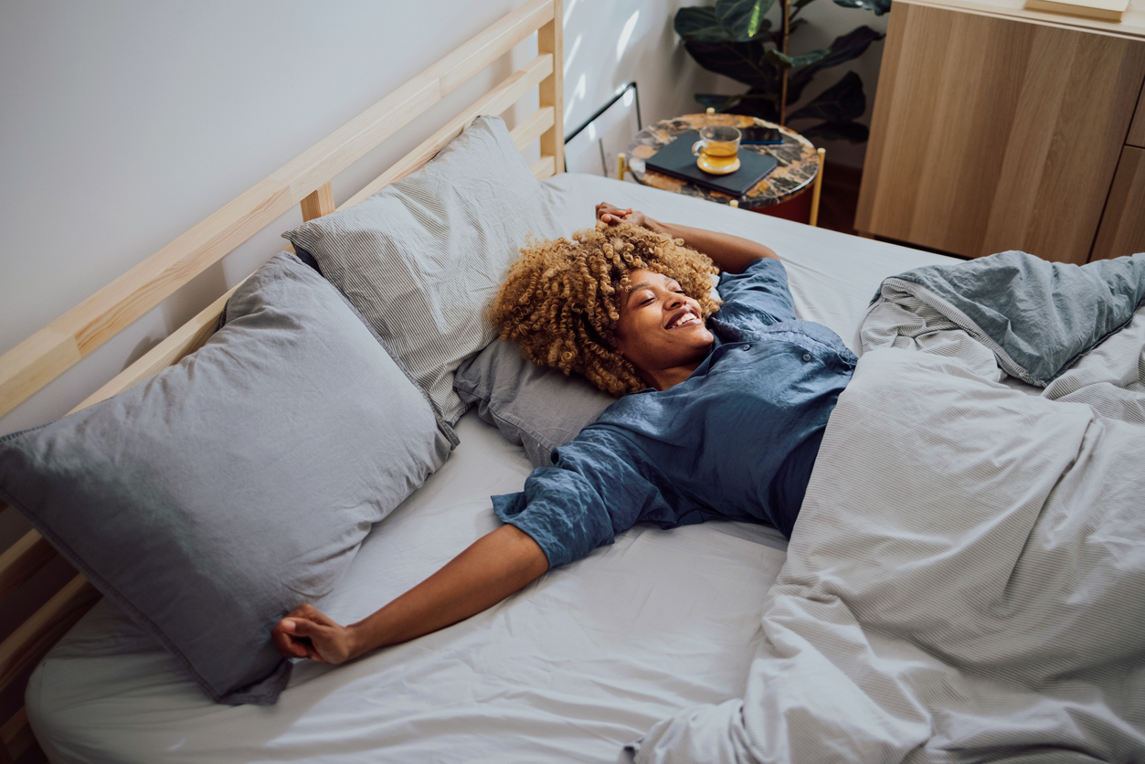 young woman daydreaming in bed