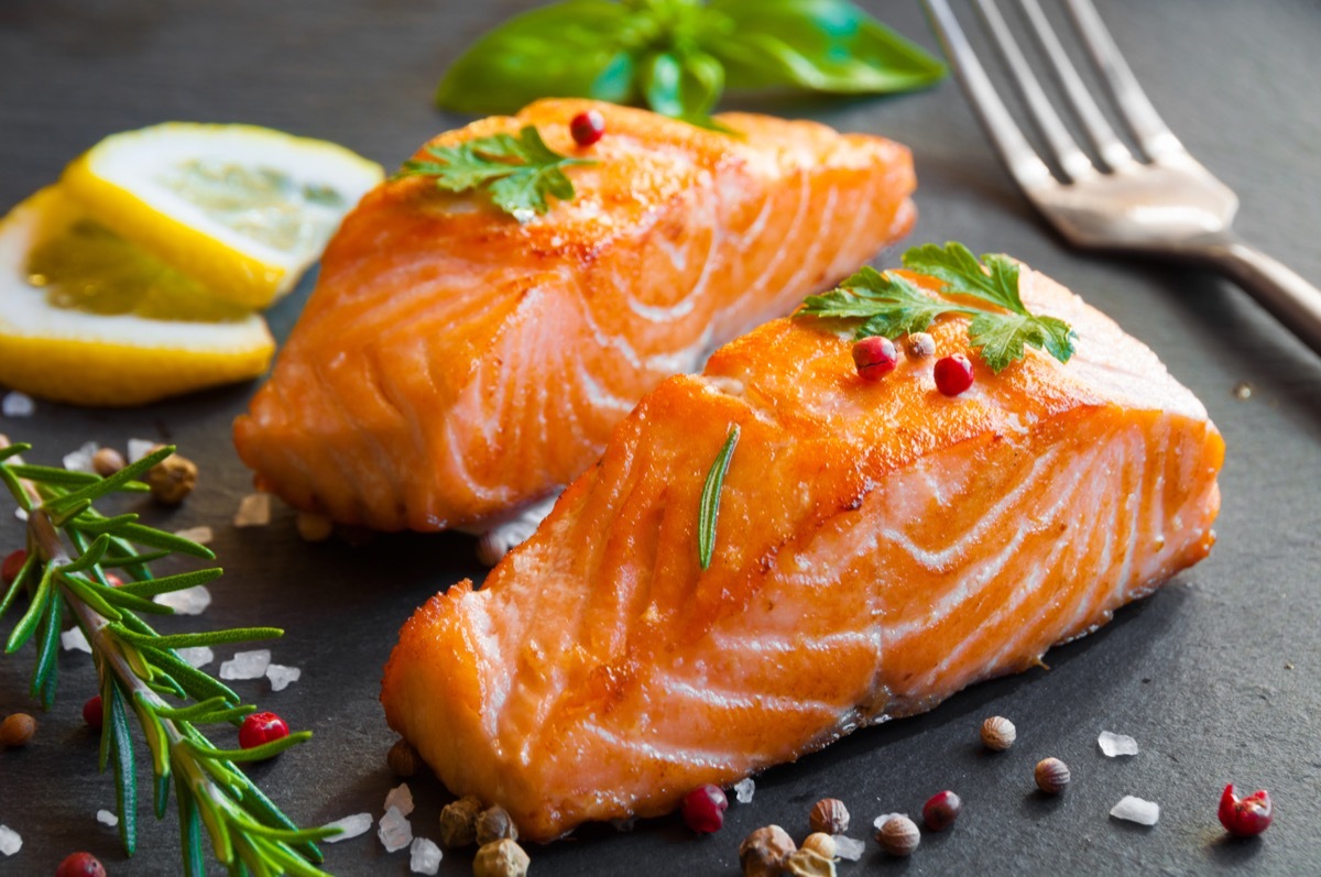 cooked salmon filets on a black slate slab