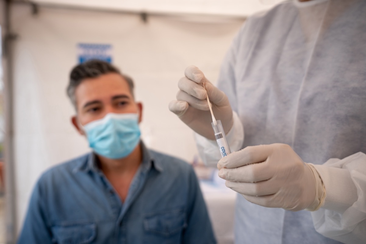 Healthcare worker putting a COVID-19 PCR test away for analysis – healthcare and medicine concepts