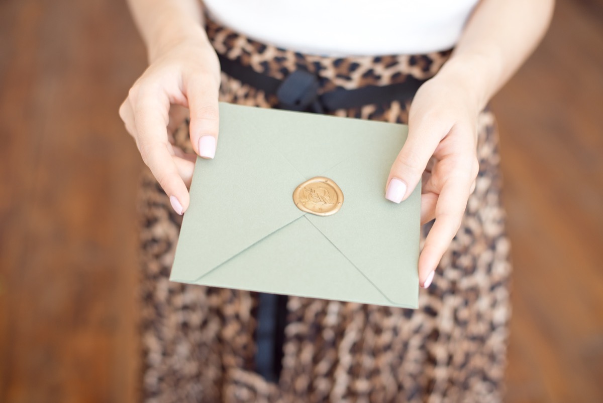 woman handing someone an invitation, old-fashioned etiquette rules