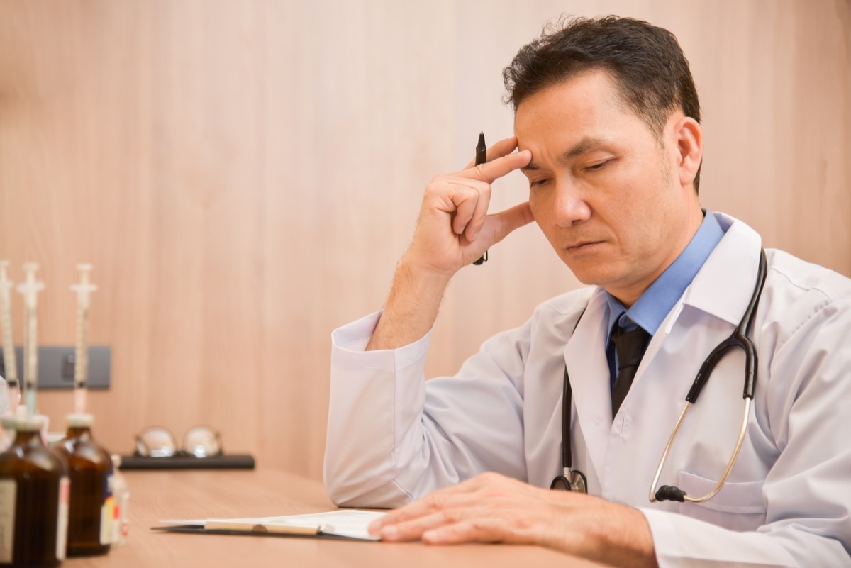 male doctor is thinking about result of examination of his patients