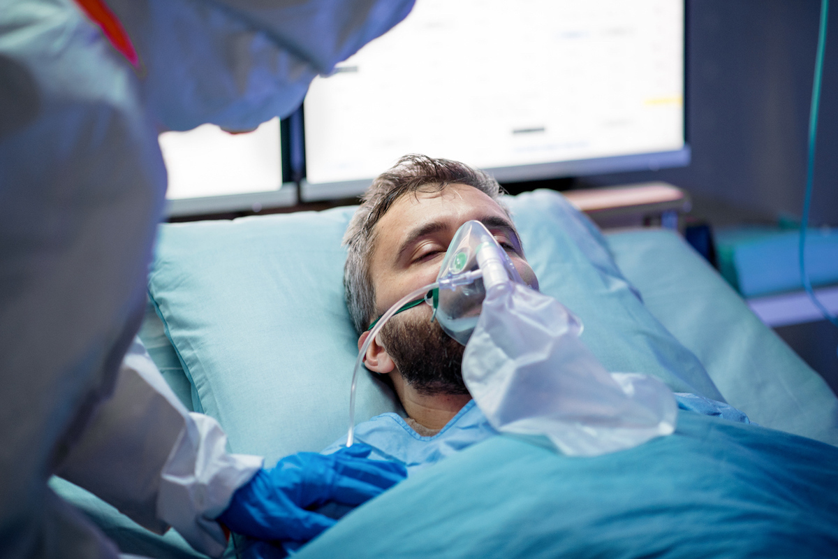 An infected patient in laying in bed in hospital