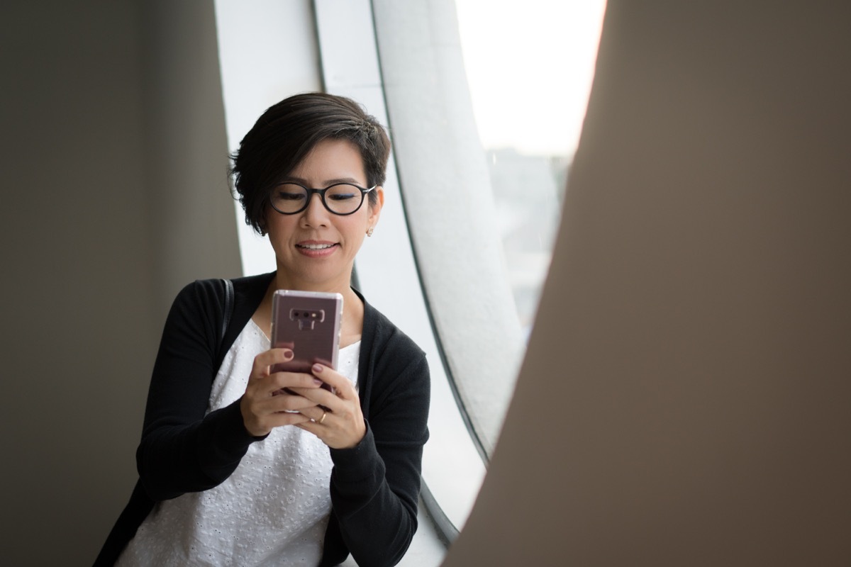 woman typing on her phone