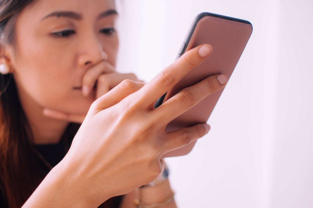 Woman looking at her phone on social media