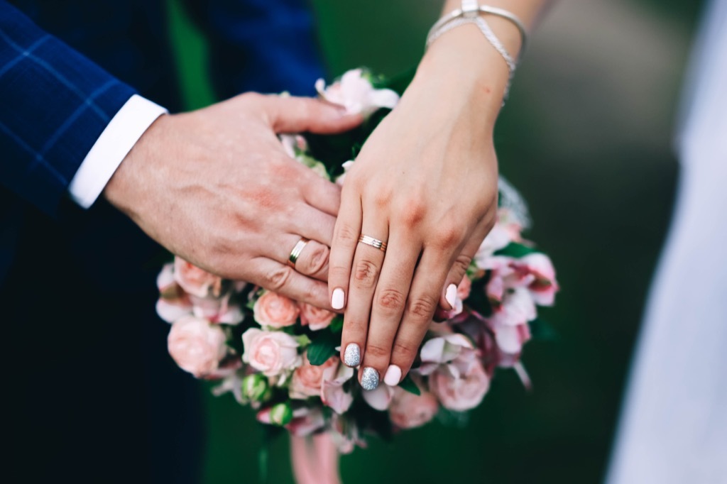 bride and groom wedding rings and wedding bouquet