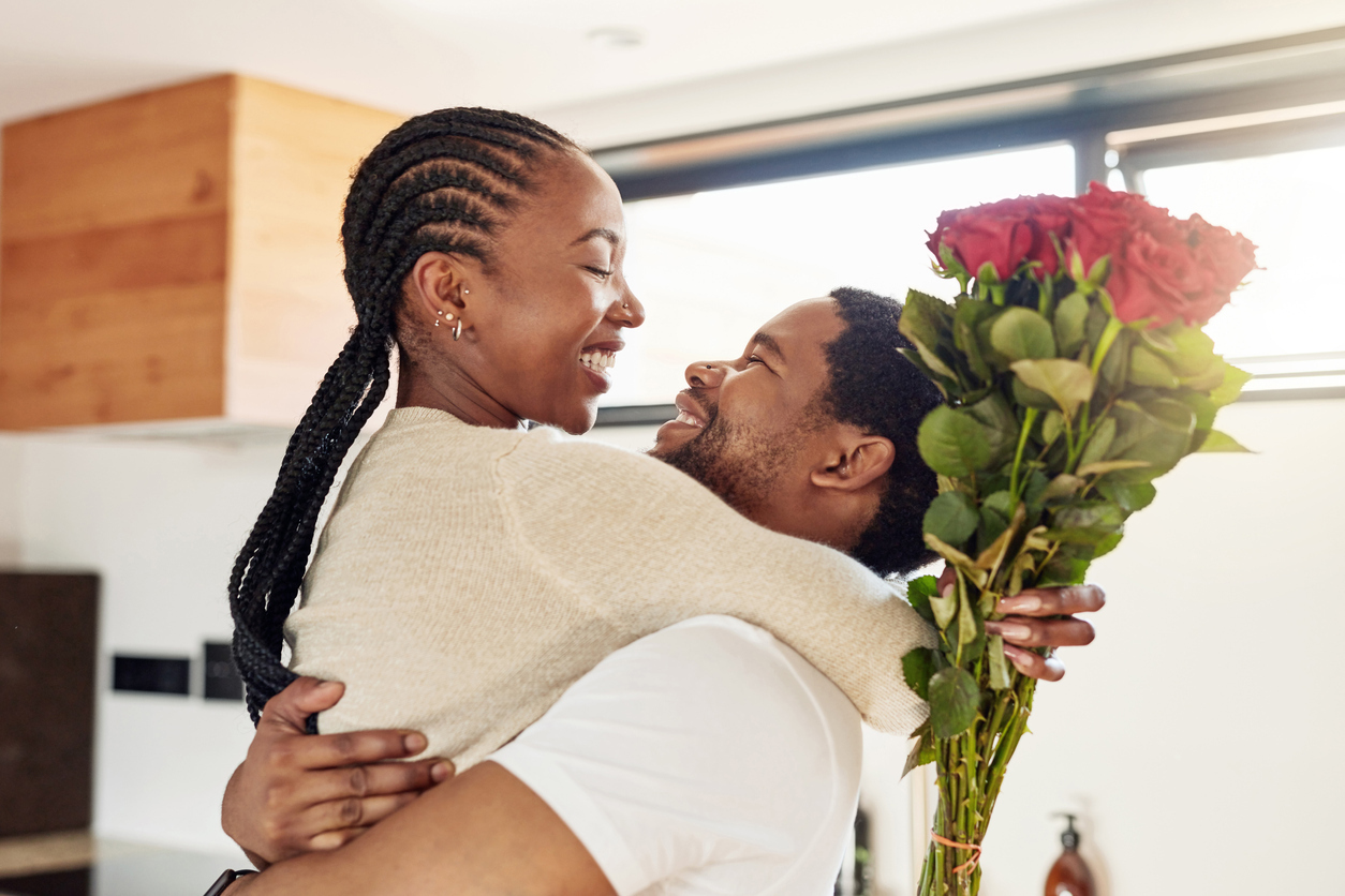 young black couple laughing and embracing