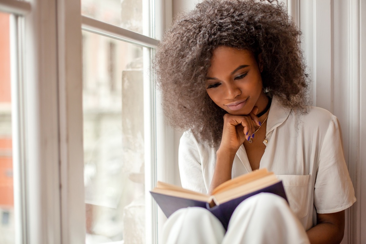 Girl reading book happily