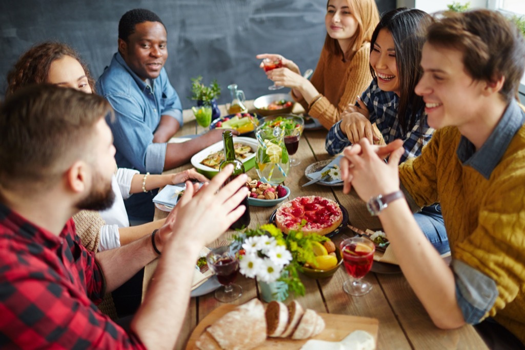 Group of friends around a table sharing a meal