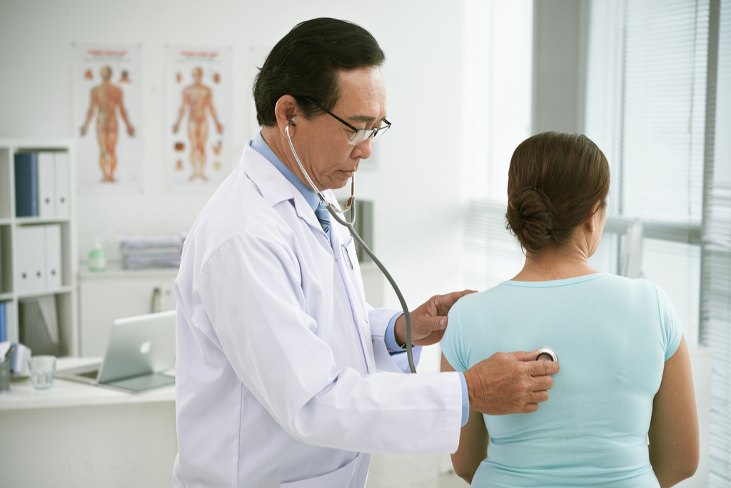 Doctor Checking Woman's Lungs