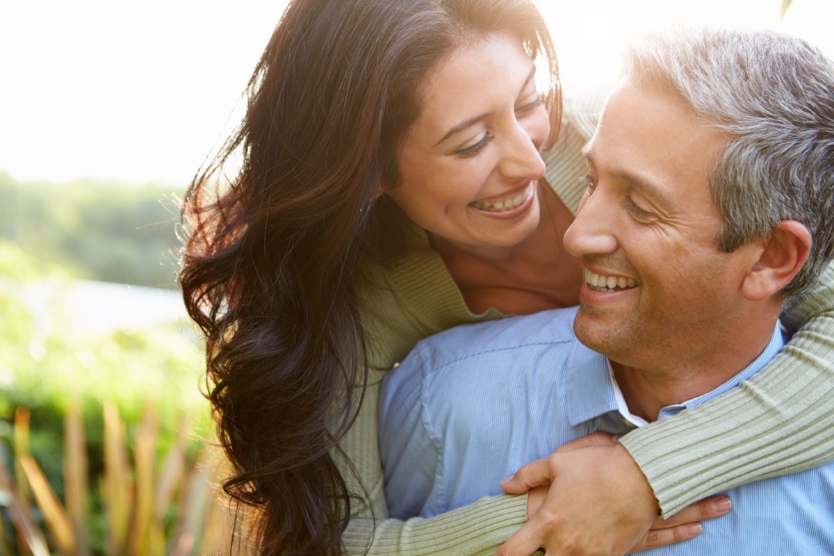 man and woman embracing in the countryside