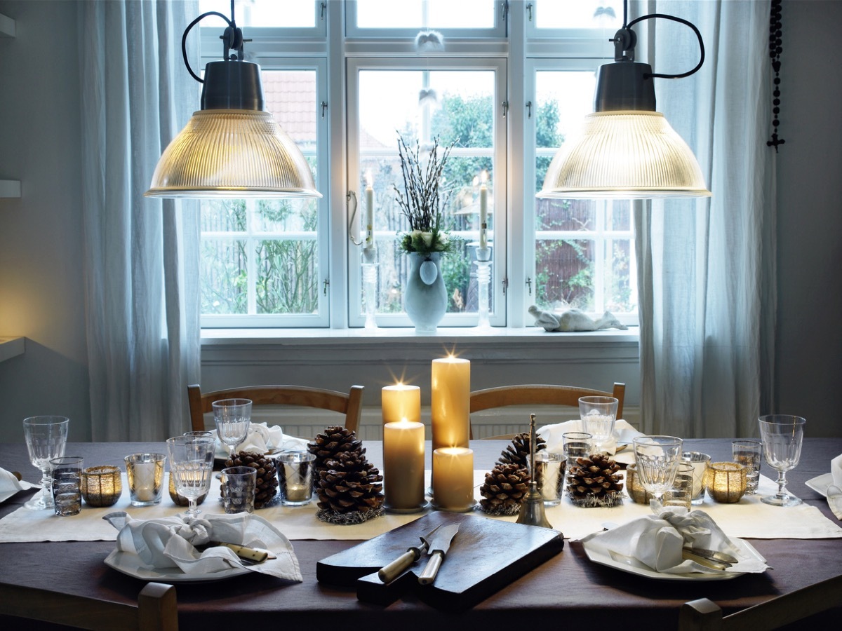 Dinner table ready for christmas dinner with pinecones and candles