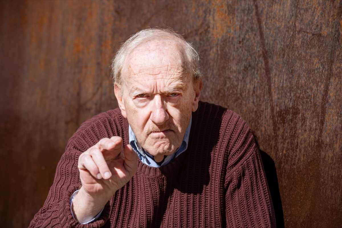 old angry man pointing and yelling at the camera