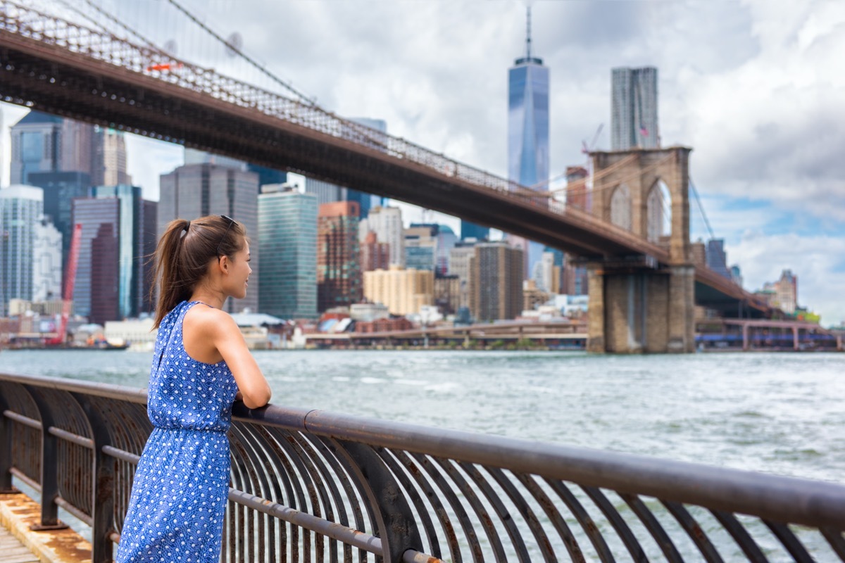 woman looking over nyc's skyscrapers