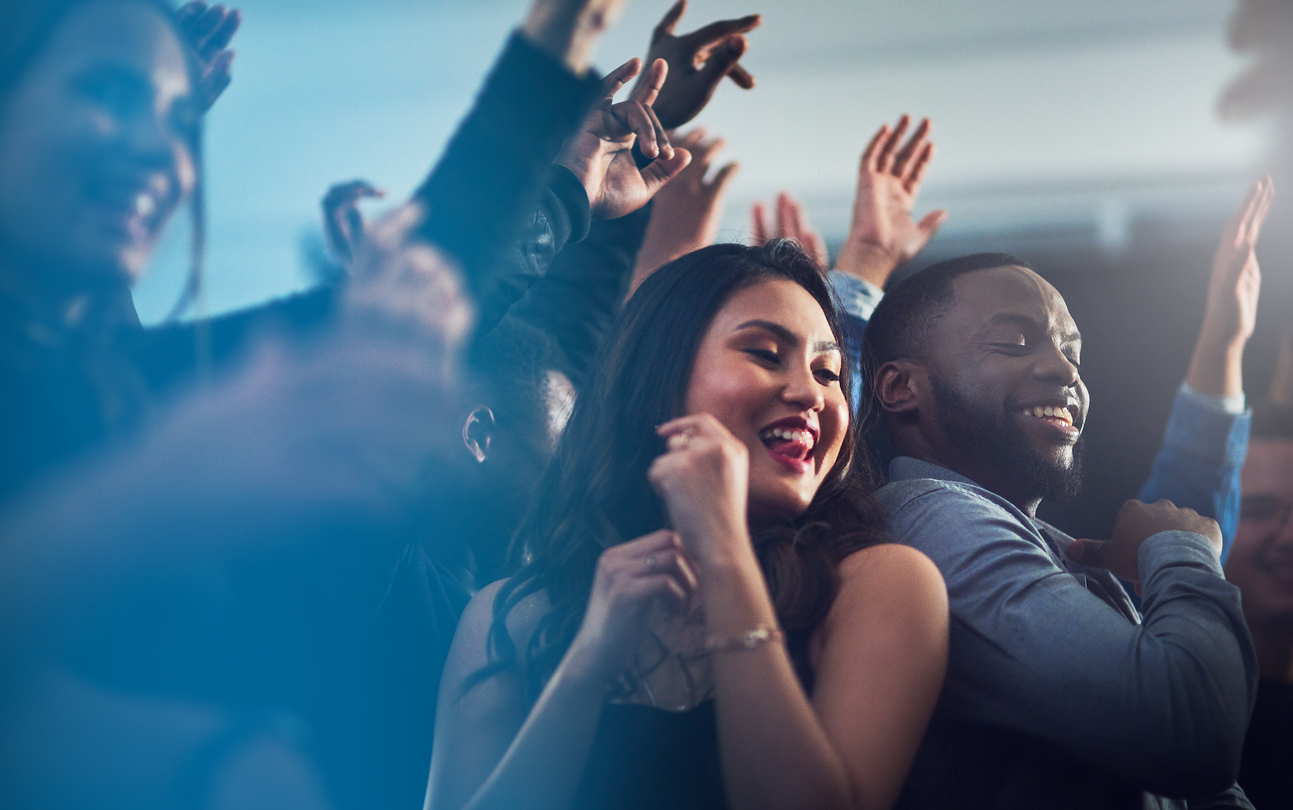 Cropped shot of an energetic young couple dancing together at a party at night