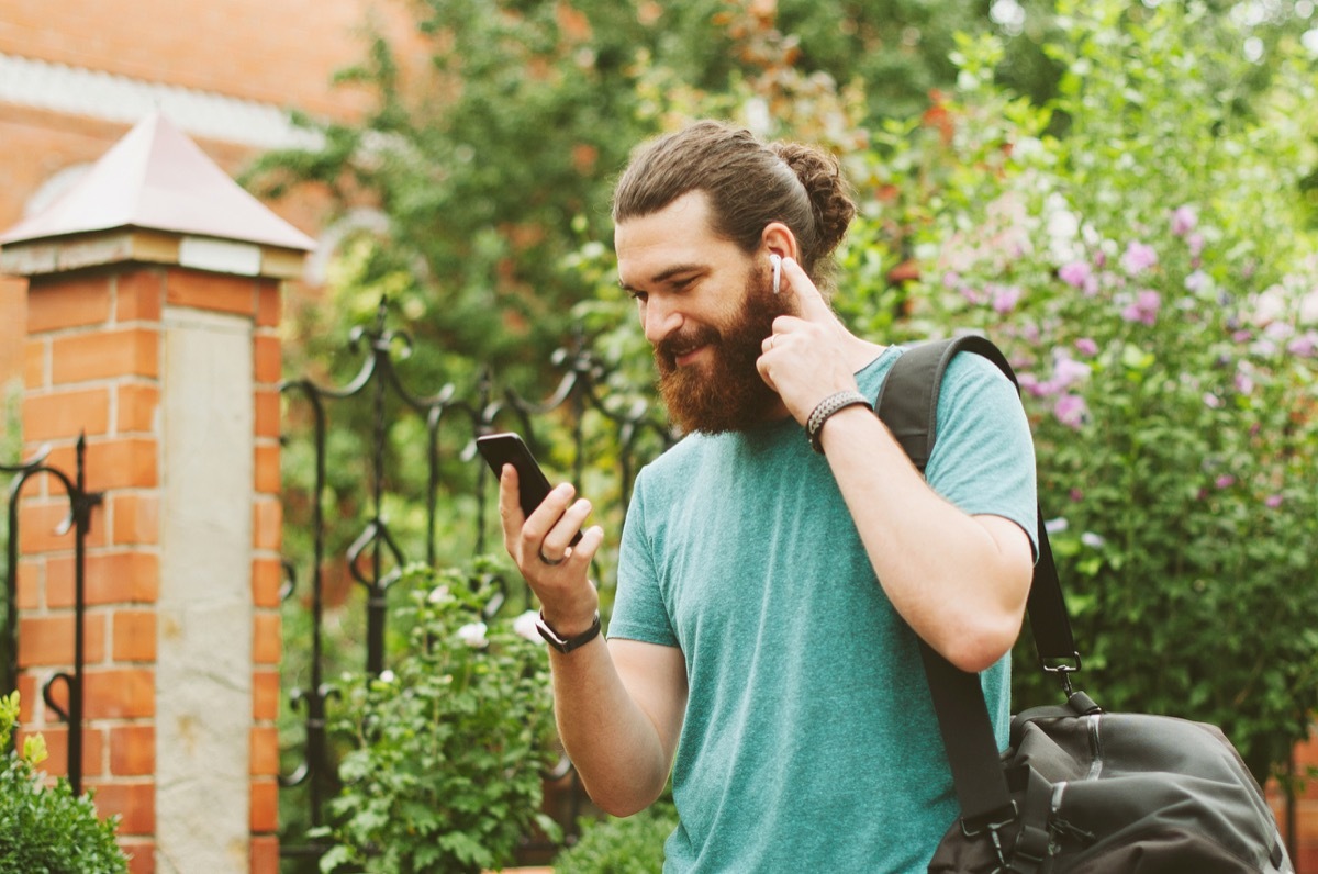 airpods or wireless earbuds in a man's ear listening to music, history predictions