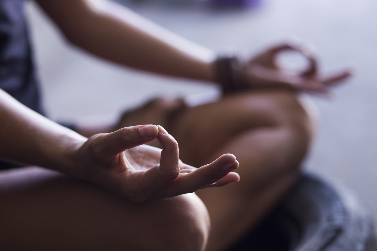 woman meditating indoors