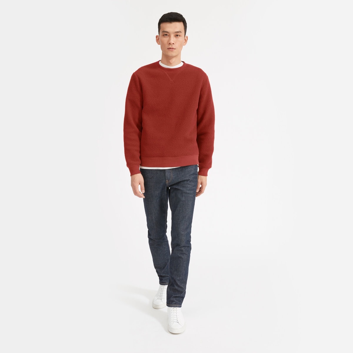 man in red Everlane fleece sweater