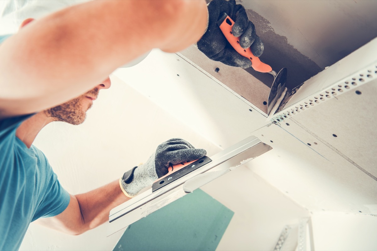 white man joining drywall panels