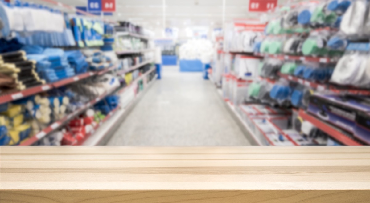 Wooden table top in front of blurred hardware store