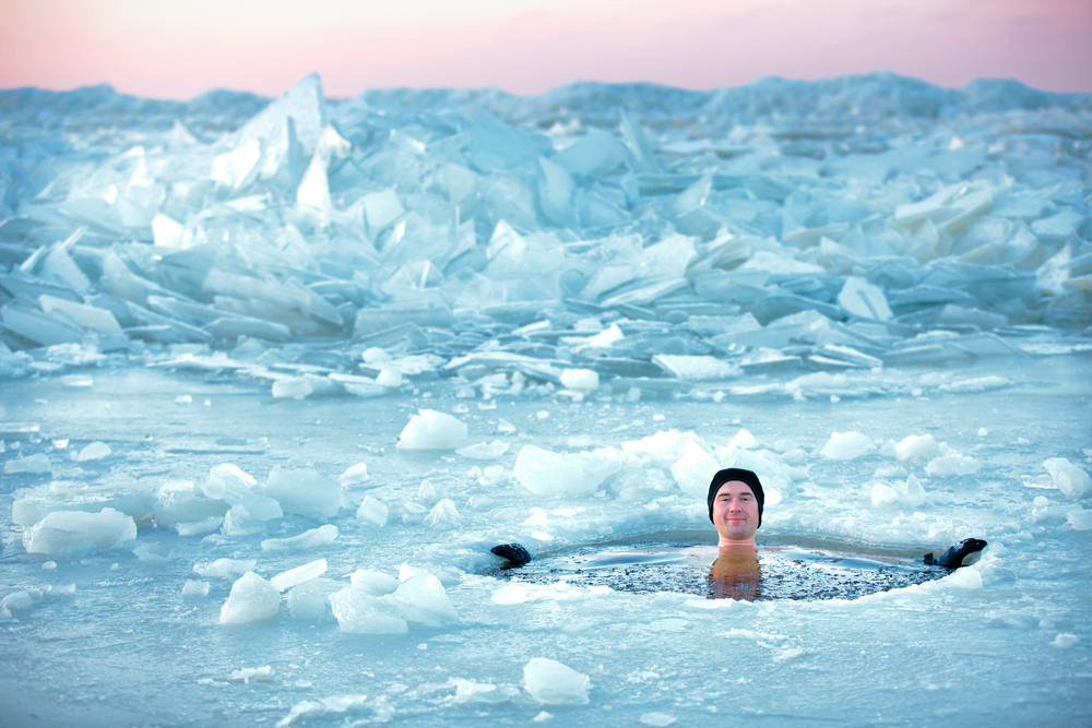 man jumps into ice pool outside