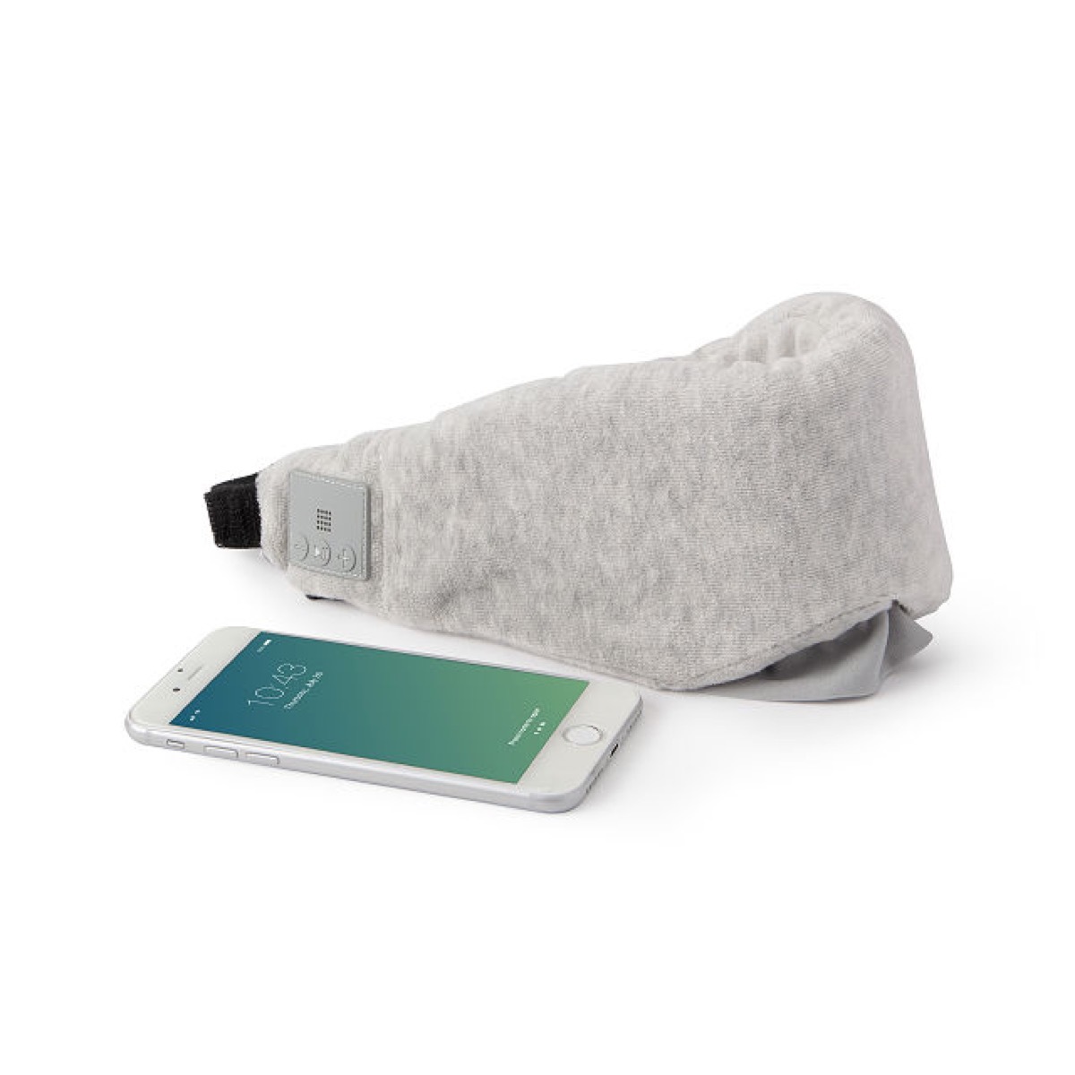 tune out musical sleep mask in gray next to white smartphone