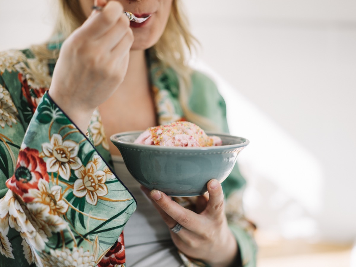 Beautiful pregnant woman eating ice cream