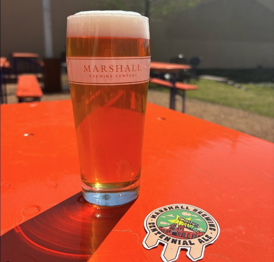 A Belcher pint glass from Marshall Brewing on a picnic table