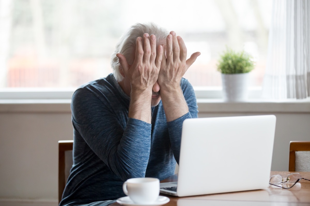 older man annoyed at laptop