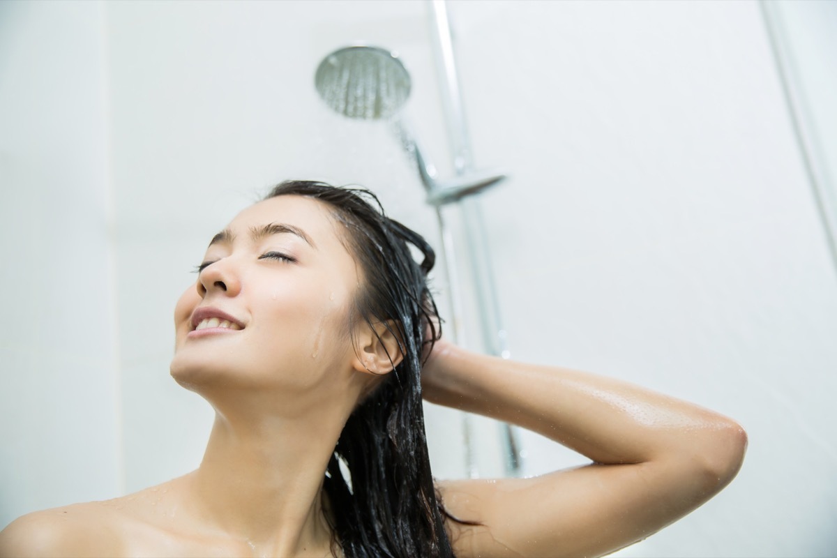 woman smiling while taking shower