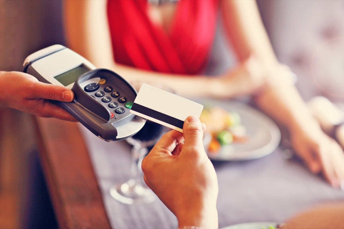 Couple getting the check at dinner who should pay