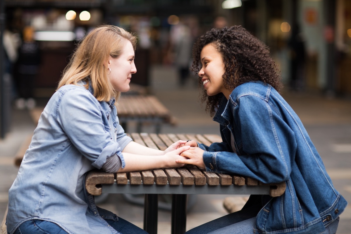 couple holding hands across the table