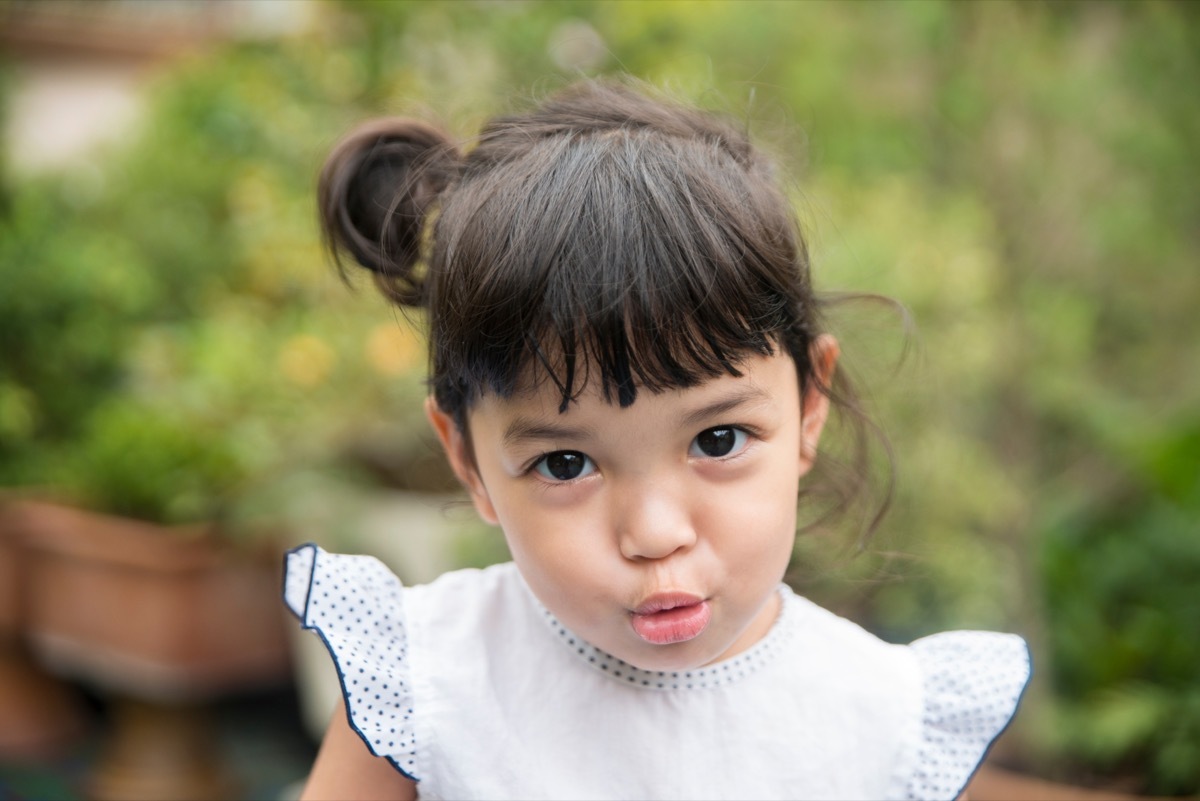 little girl making a pucker face at the camera