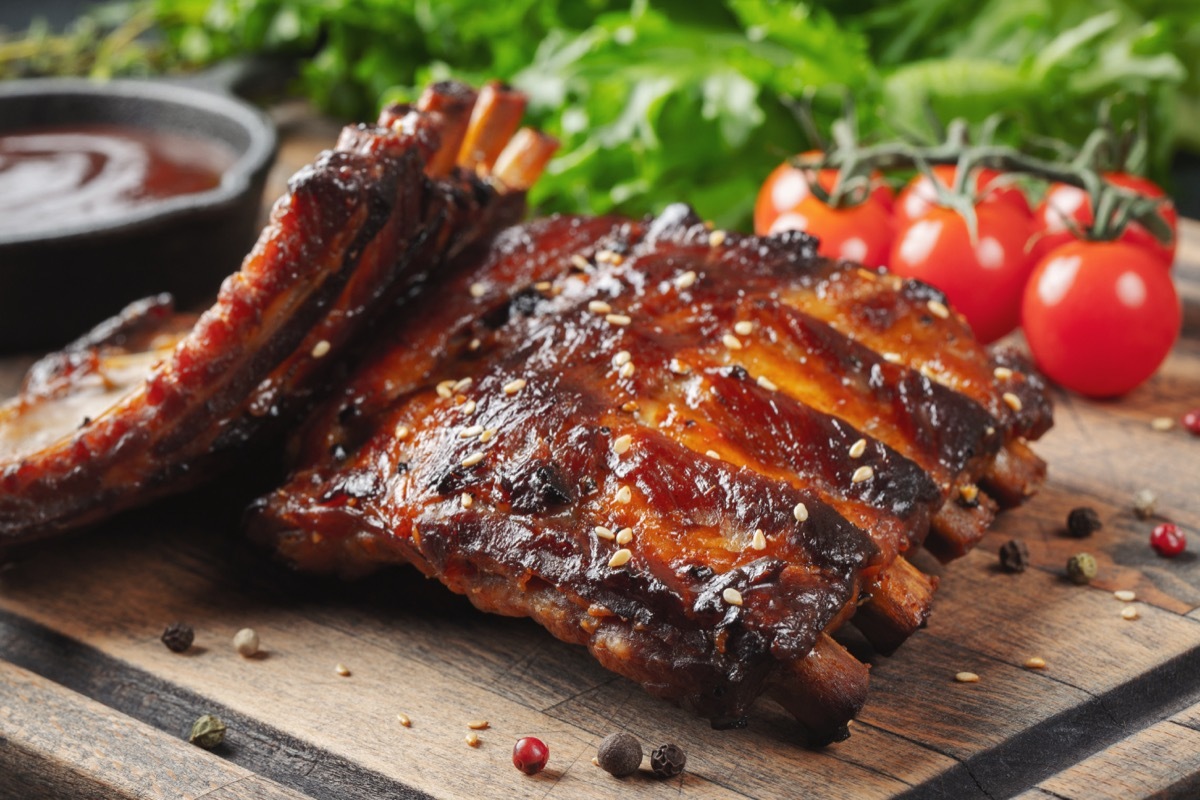 bbq ribs, tomato, sauce, wooden board