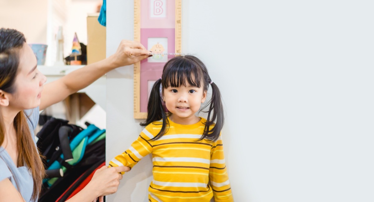 young asian child getting measured