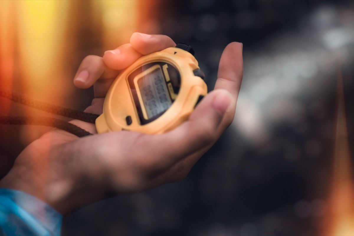 Man holding digital stopwatch