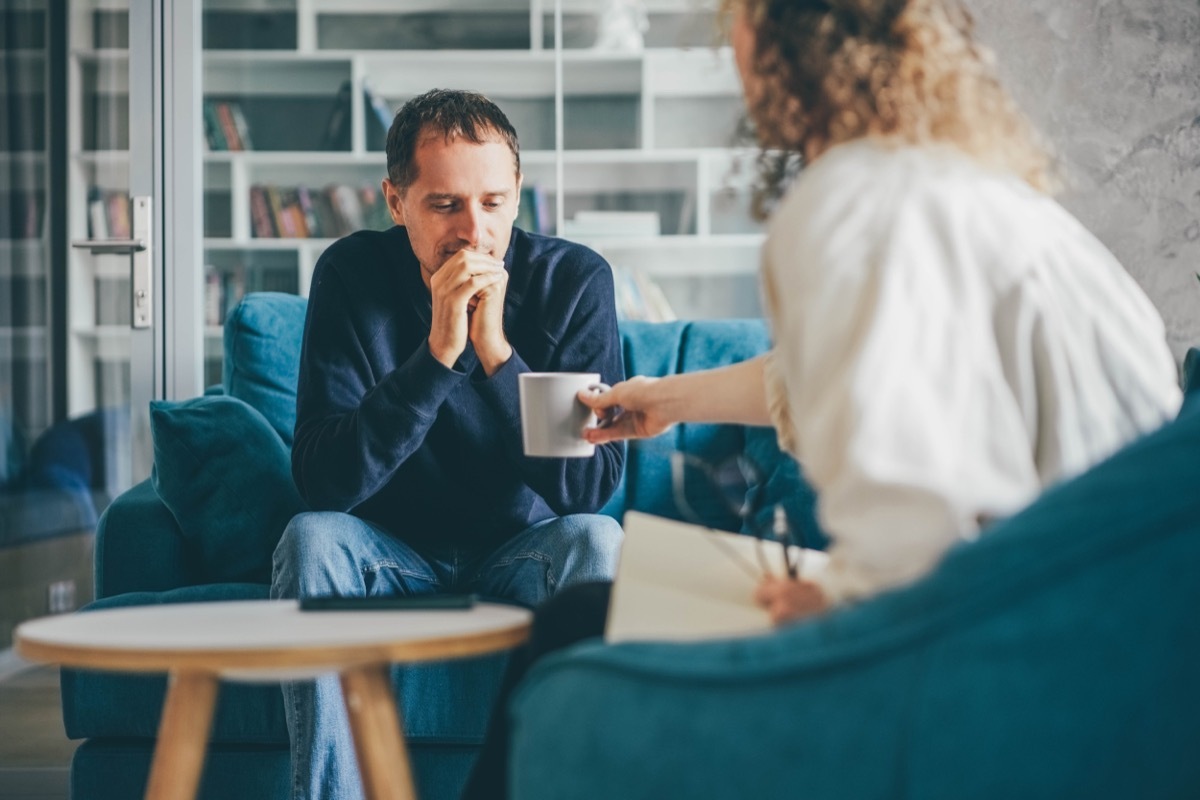 Woman Offering Man a Hot Beverage