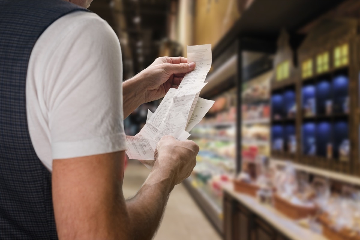 man looking at receipt