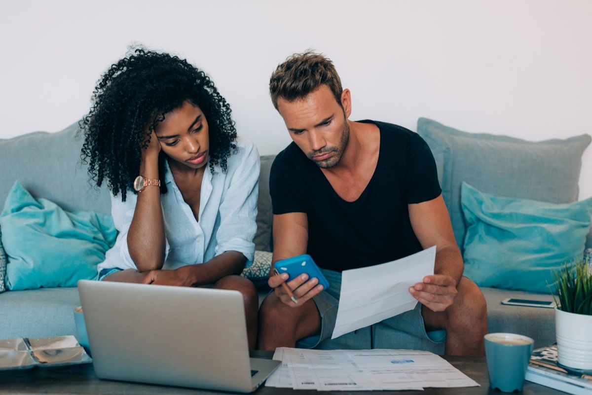 frustrated couple looking at their bills