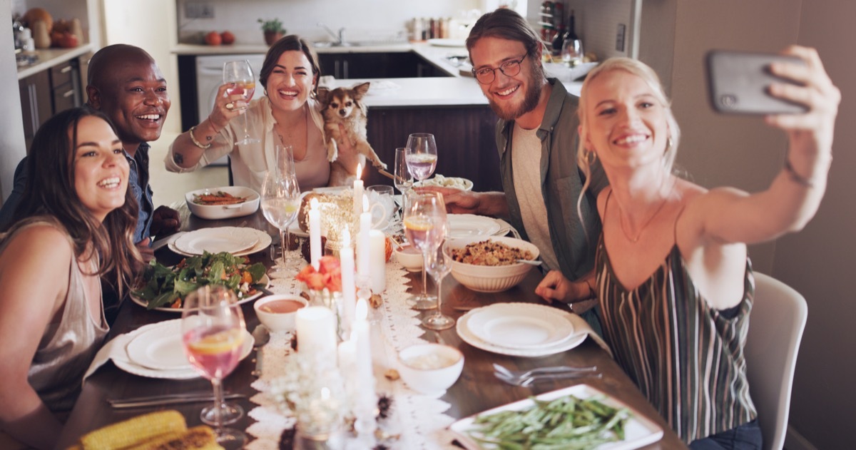 people gather indoors, eat together