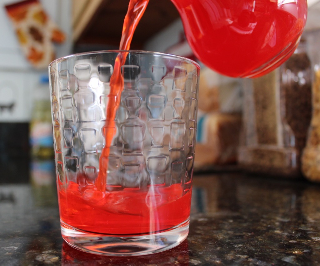 red drink is poured from pitcher into tumbler glass, fact about nebraska