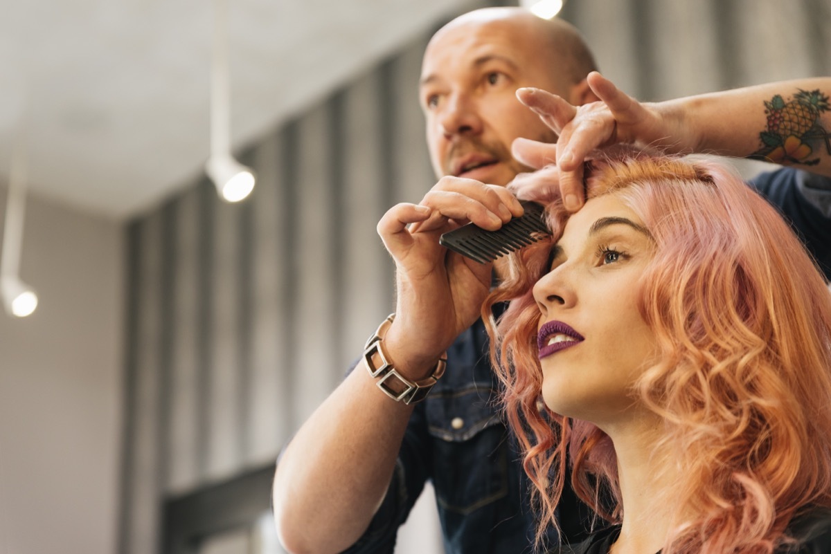 Hairstylist Finishing up a Client with Pink Hair