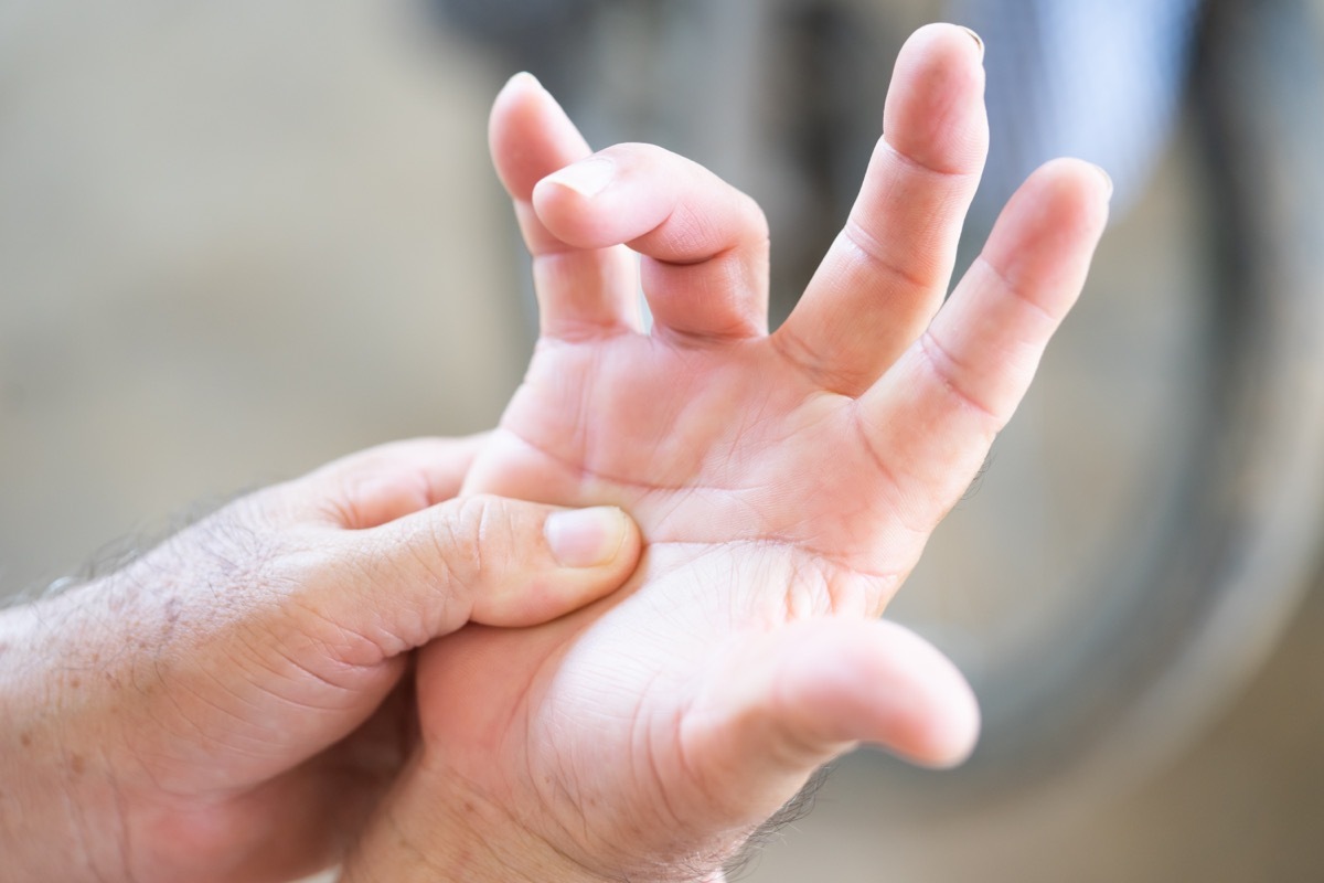 Senior old man having problem trigger finger.Hand trigger finger lock concept healthy.