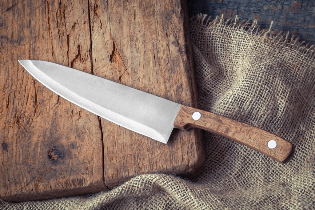 An old knife on a cutting board