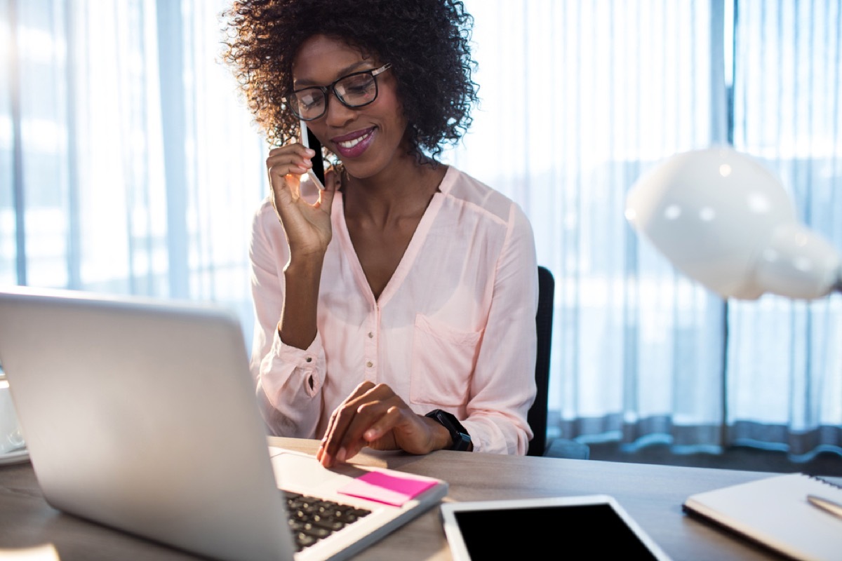 black woman talking on the phone in her office in front of laptop, hings not to say to customer service rep