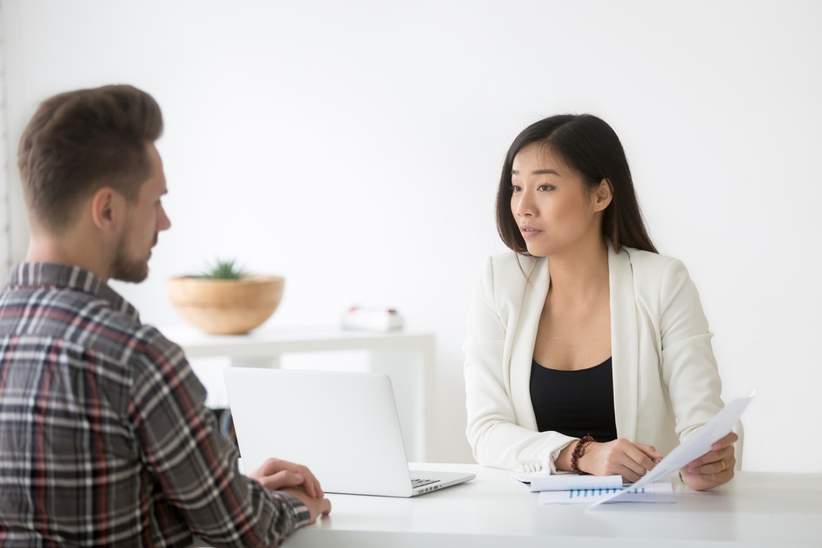 man talking to asian woman at job interview