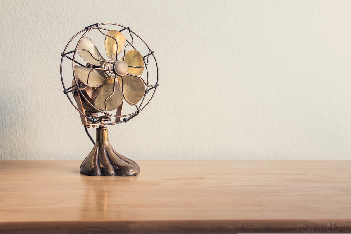 antique fan on wooden desk