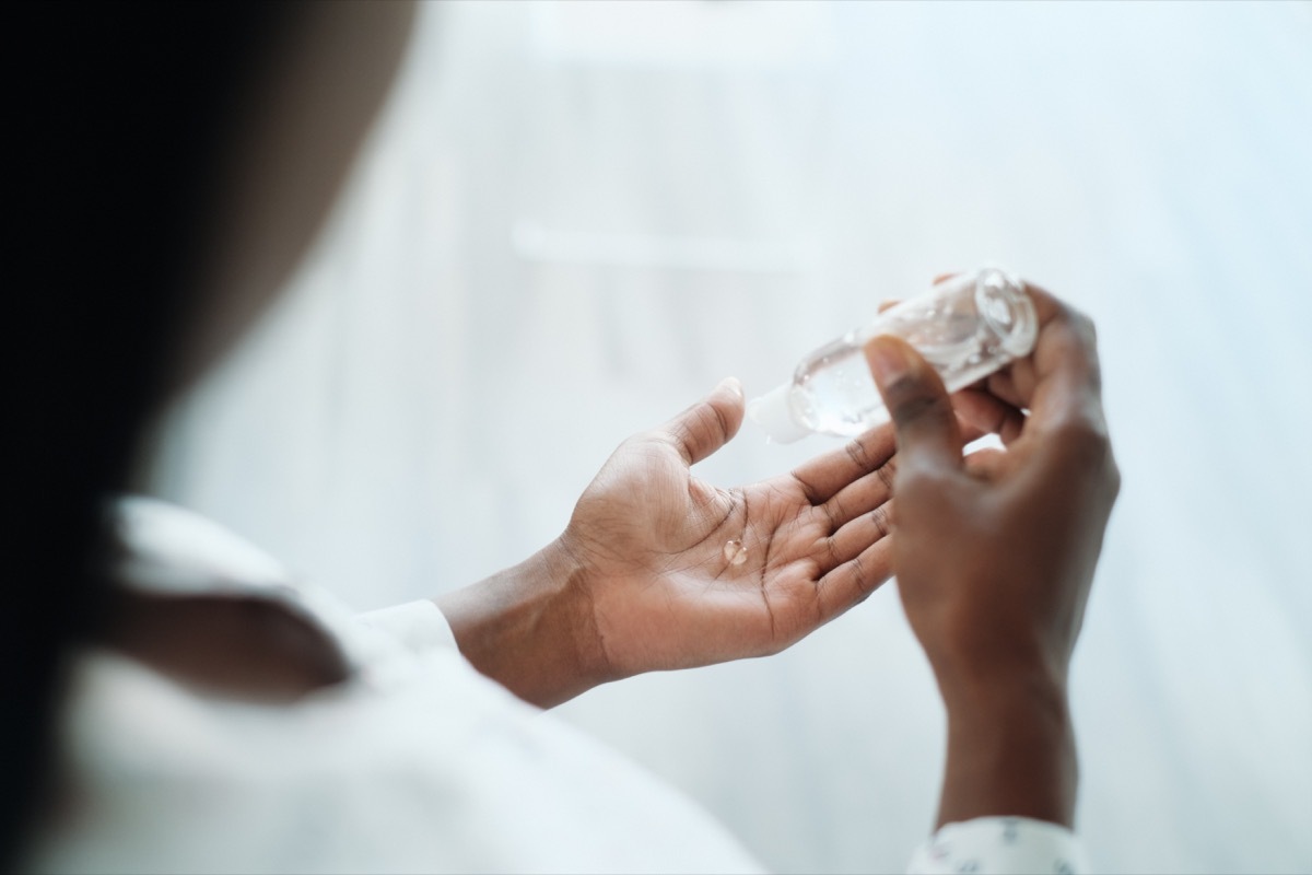 woman using liquid hand sanitizer. girl using alcohol-based gel to disinfect hand skin against virus, germs, bacteria for healthy lifestyle