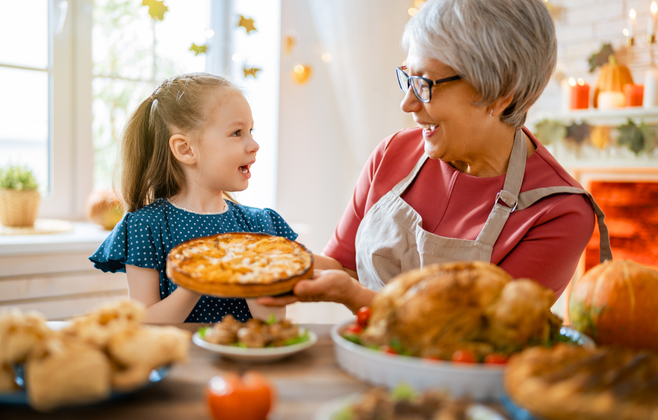 young girl and grandma making pie