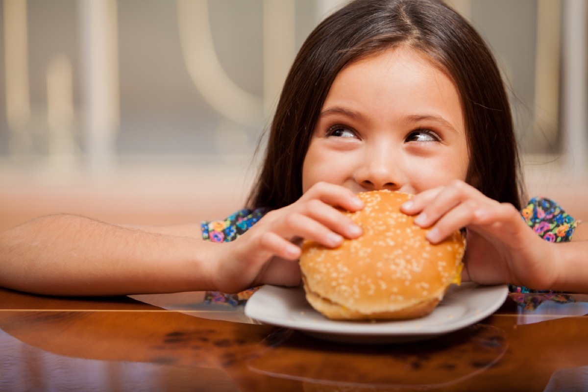 little girl eating hamburger, bad parenting